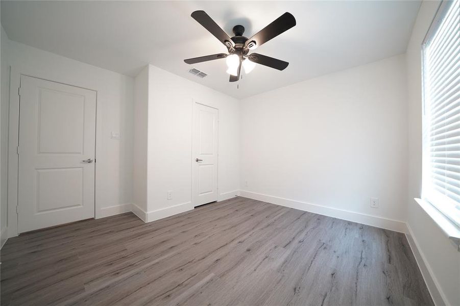 Unfurnished bedroom featuring light wood-style floors and ceiling fan