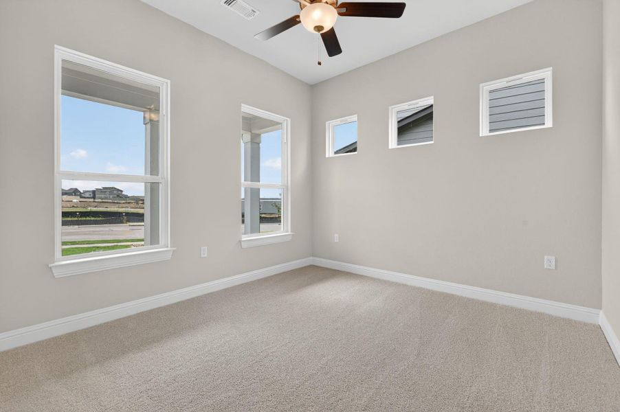 Spare room with light carpet and ceiling fan