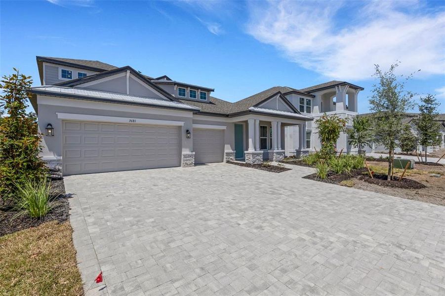 Front exterior of a new home in Creeks Edge at Twin Rivers, Parrish, FL, highlighting curb appeal (Image 24).