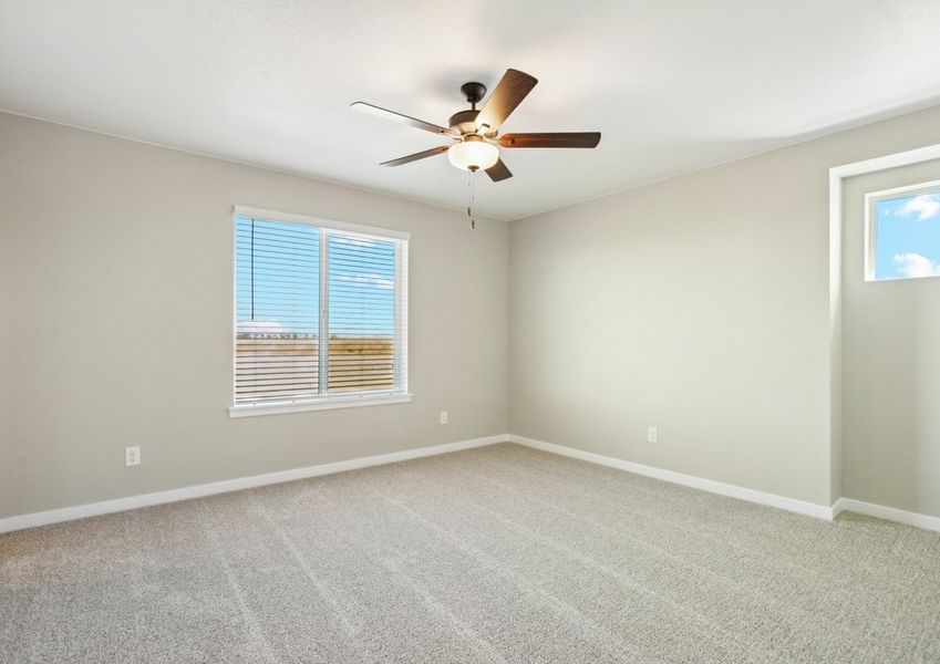 The master bedroom is spacious with a ceiling fan.