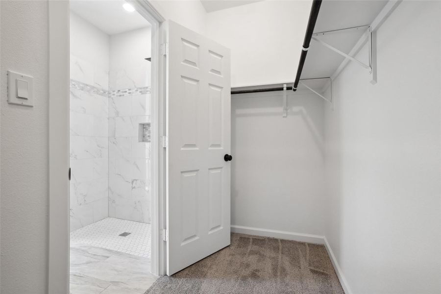 Walk in closet with carpet floors Walk in closet with carpet floors