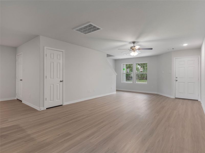 Spacious living area with a modern ceiling fan, perfect for comfort and relaxation.