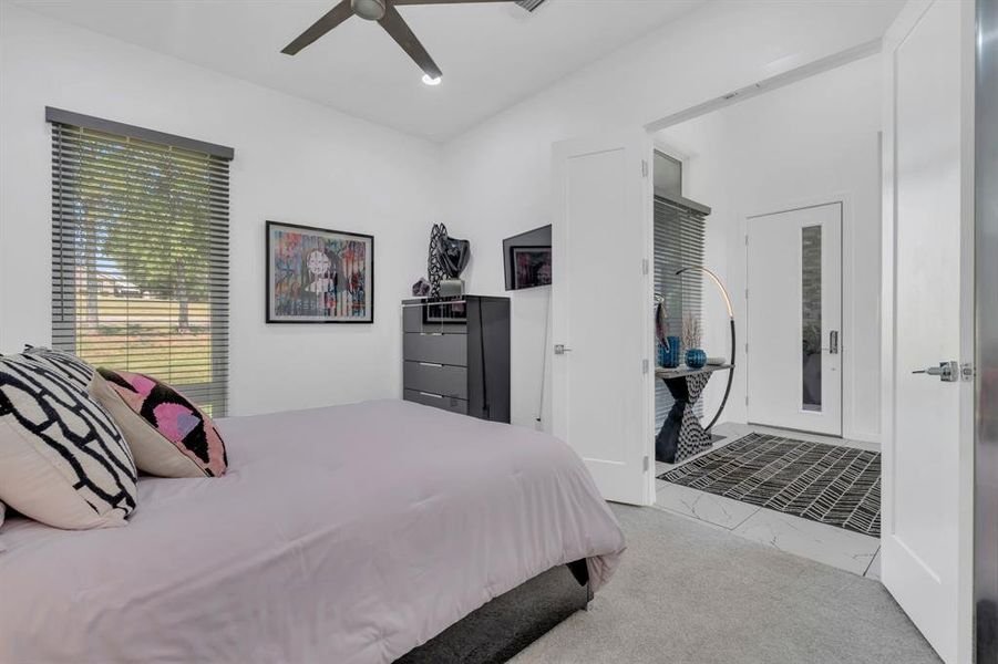 Bedroom with light colored carpet, ceiling fan, and recessed lighting