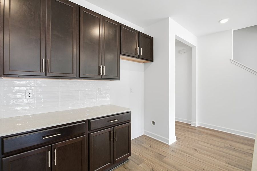 A kitchen with black cabinets. A kitchen with black cabinets.