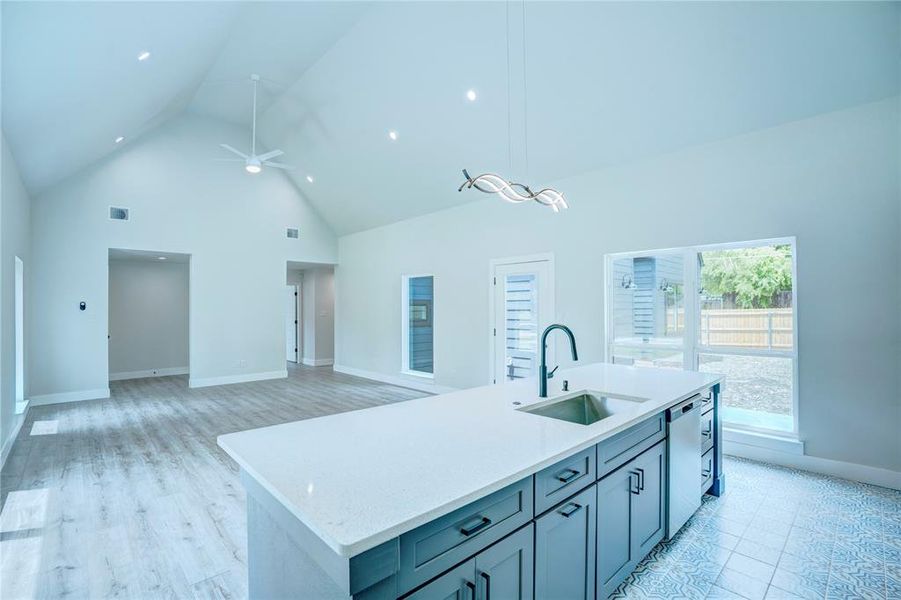 Open-concept living area featuring a vaulted ceiling with a ceiling fan and recessed lighting