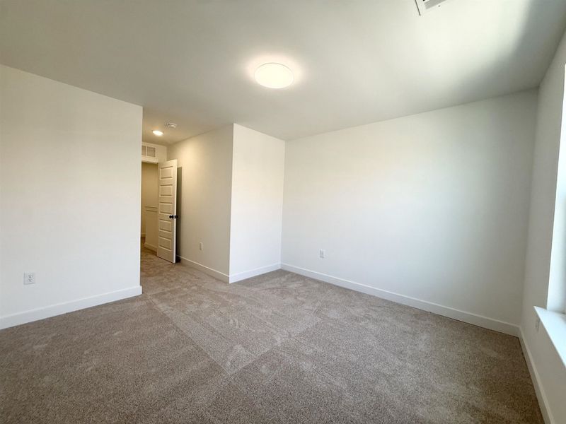 Unfurnished room with carpet and baseboards