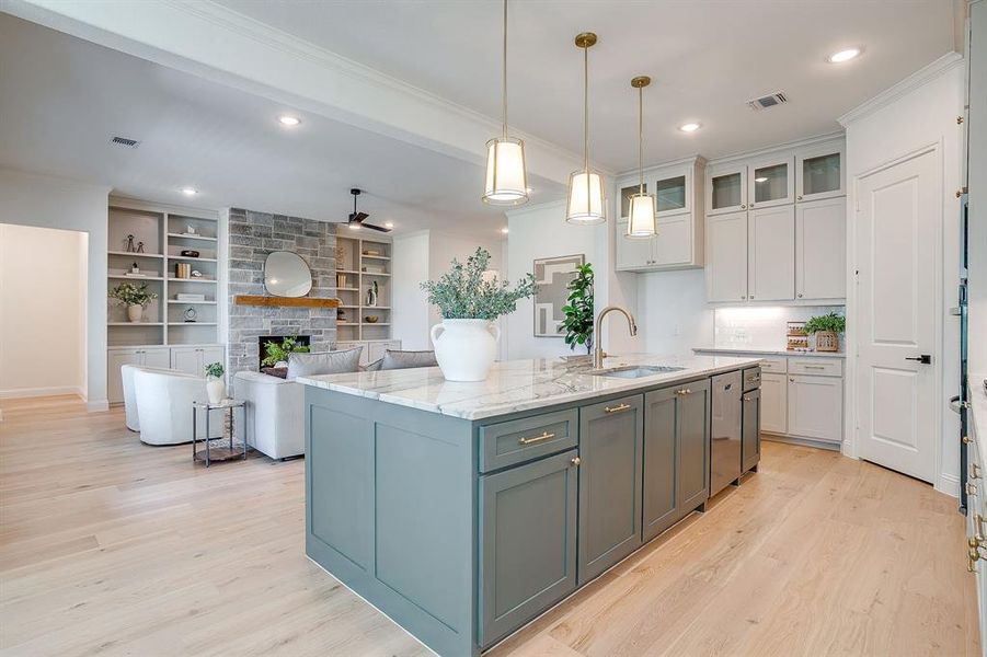 Kitchen with custom cabinets to the ceiling, leathered Quartzite counters, tile backsplash, decorative lighting, ample storage, soft close doors and drawers, and gas cooktop. Kitchen with custom cabinets to the ceiling, leathered Quartzite counters, tile backsplash, decorative lighting, ample storage, soft close doors and drawers, and gas cooktop.