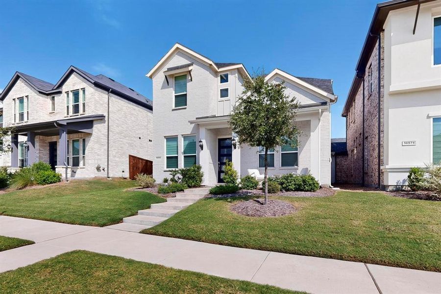 View of front of house featuring a front yard and brick siding View of front of house featuring a front yard and brick siding