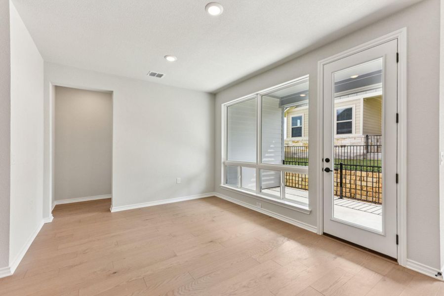 Empty room with light wood-type flooring and recessed lighting