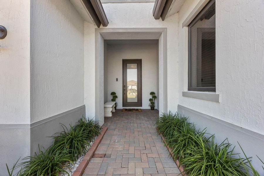 Entrance to property with stucco siding