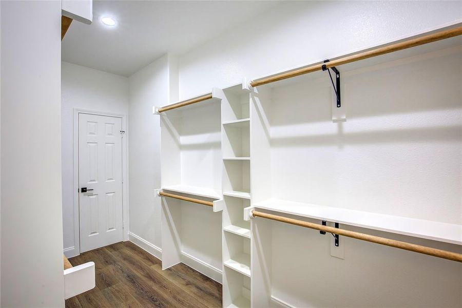 Spacious closet featuring dark wood-type flooring Spacious closet featuring dark wood-type flooring