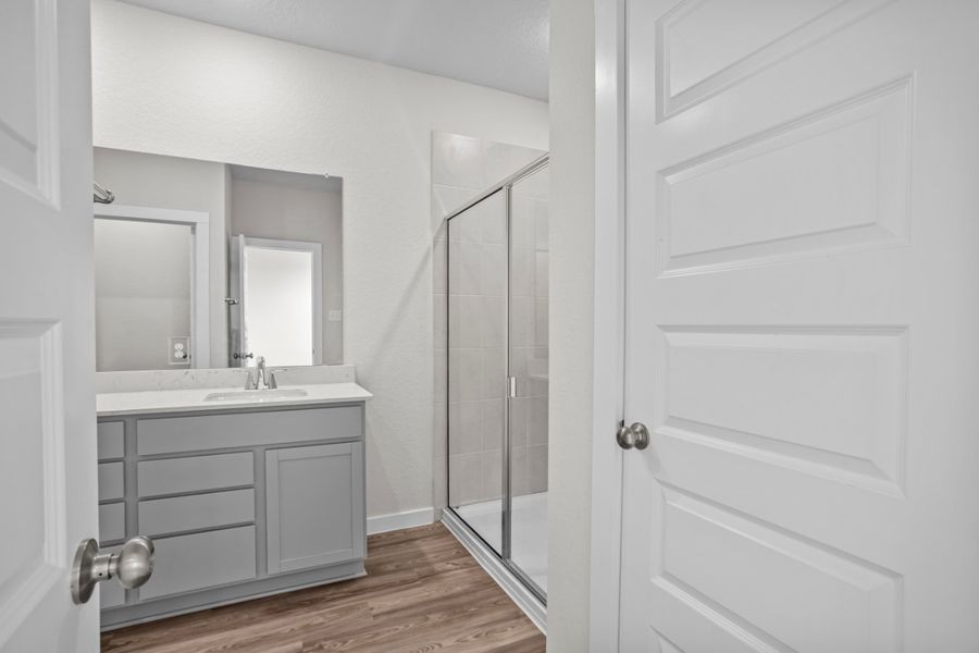 A bathroom with a glass shower. A bathroom with a glass shower.