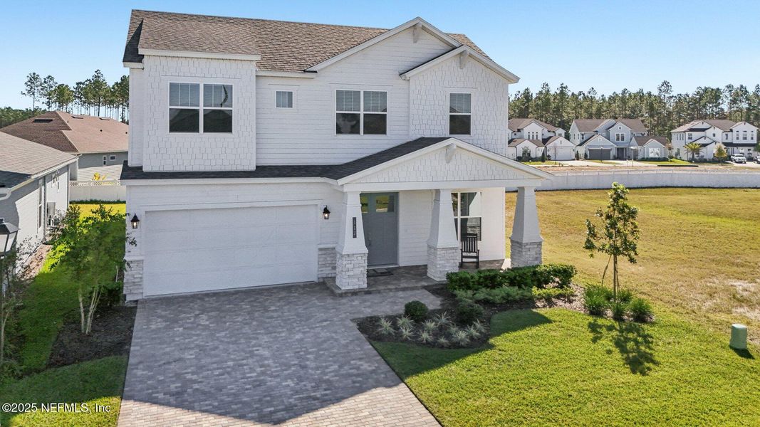 Front exterior of a new home in Courtney Chase, St. Augustine, FL, highlighting curb appeal (Image 2). Front exterior of a new home in Courtney Chase, St. Augustine, FL, highlighting curb appeal (Image 2).
