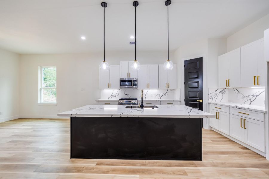 Spacious kitchen featuring a large black island, perfect for meal prep, entertaining, and adding a modern, stylish touch. Spacious kitchen featuring a large black island, perfect for meal prep, entertaining, and adding a modern, stylish touch.