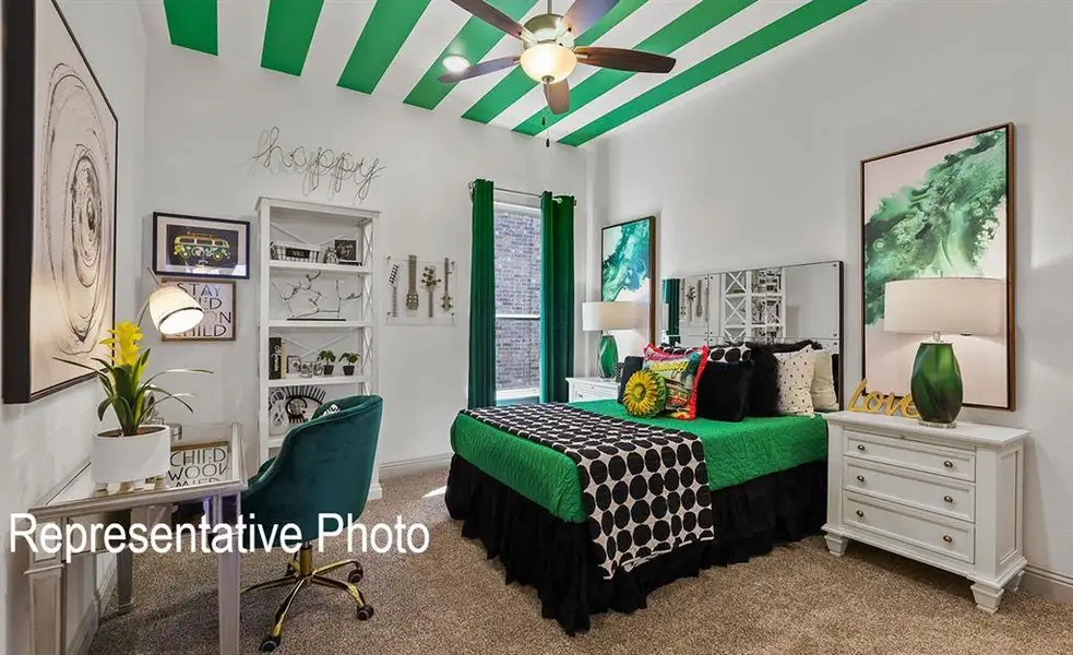 White-painted bedroom featuring a ceiling fan, a patterned ceiling with green stripes, and carpeting White-painted bedroom featuring a ceiling fan, a patterned ceiling with green stripes, and carpeting