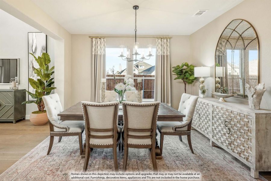 Formal dining room with wood table, upholstered chairs, chandelier, and white sideboard with arched mirror