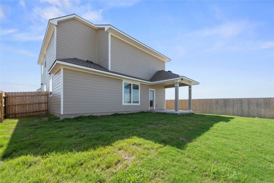 A spacious backyard with a private covered patio awaits outdoor enjoyment.