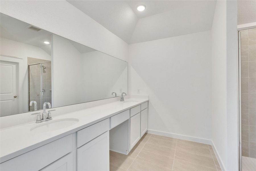 Full bathroom with double vanity, a stall shower, light tile patterned floors, recessed lighting, and lofted ceiling Full bathroom with double vanity, a stall shower, light tile patterned floors, recessed lighting, and lofted ceiling
