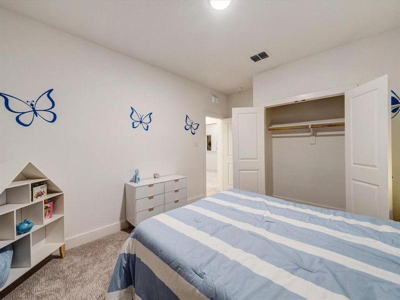 Bedroom with light colored carpet and a closet Bedroom with light colored carpet and a closet