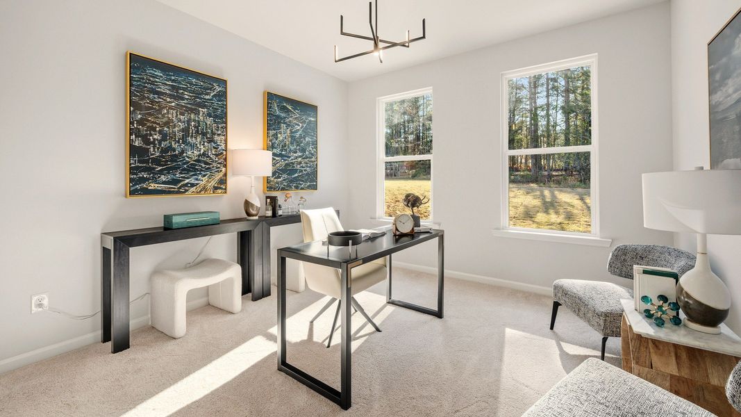 Bedroom with bright natural lighting from windows and carpet, used as an office Bedroom with bright natural lighting from windows and carpet, used as an office