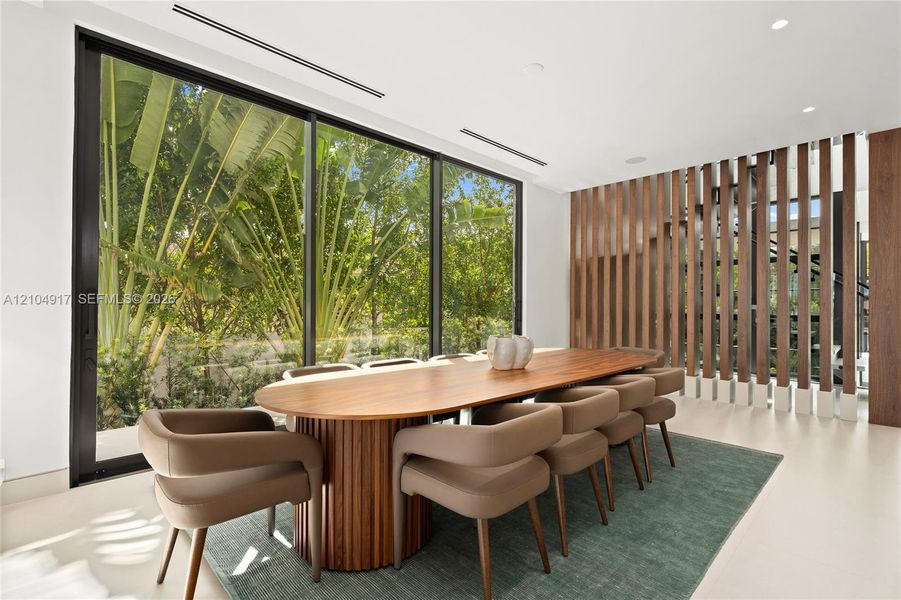 Floor-to-ceiling windows, recessed lighting, wood-finish slatted wall partition, and light-toned flooring