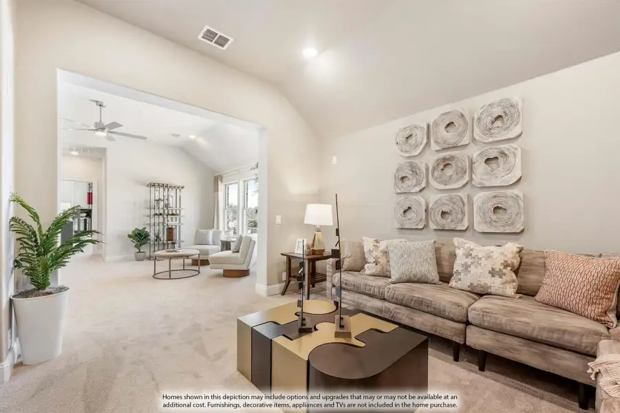 Open-concept living room with vaulted ceiling, neutral sectional sofa, and view into adjoining sitting room with ceiling fan