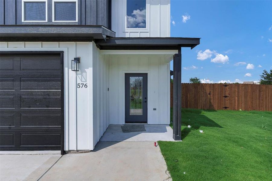 Property entrance featuring board and batten siding