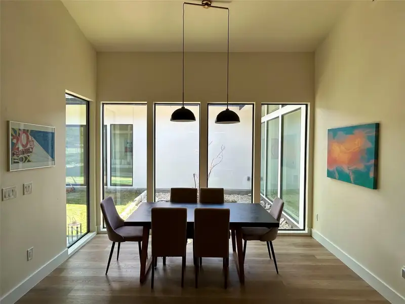 Dining space with wood finished floors Dining space with wood finished floors