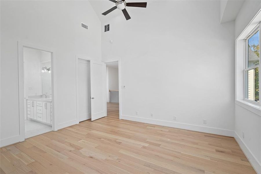 Another view of the same room, showing the shared bathroom in view as well as a door to the closet.