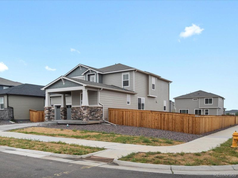 Front exterior of a new home in Ridgeline Vista: The Flora Collection, Brighton, CO, highlighting curb appeal (Image 26). Front exterior of a new home in Ridgeline Vista: The Flora Collection, Brighton, CO, highlighting curb appeal (Image 26).