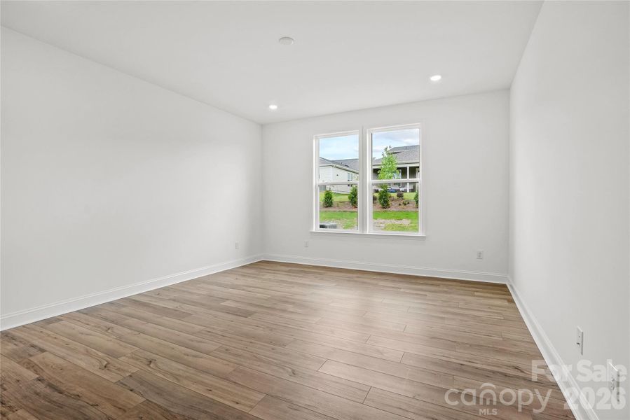 Large primary bedroom with continued EVP flooring Large primary bedroom with continued EVP flooring