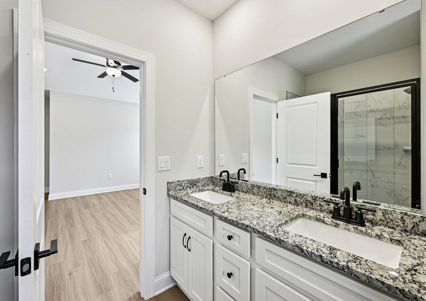 The master bathroom includes a large vanity with a glass-enclosure shower The master bathroom includes a large vanity with a glass-enclosure shower