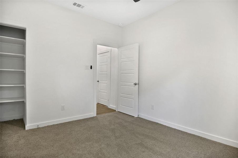 Unfurnished bedroom with carpet