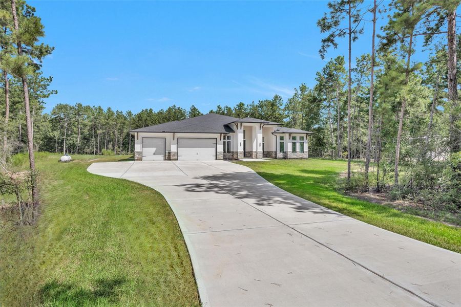 The large oversized driveway and pad offers an incredible amount of parking leading to a three-car Garage.