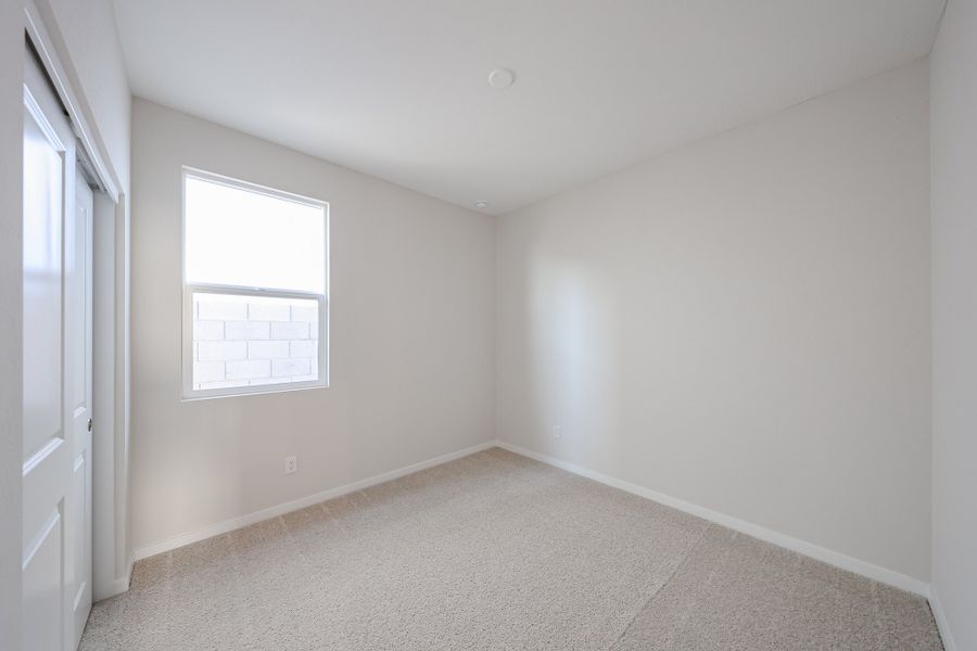 A room with a window and a carpet. A room with a window and a carpet.