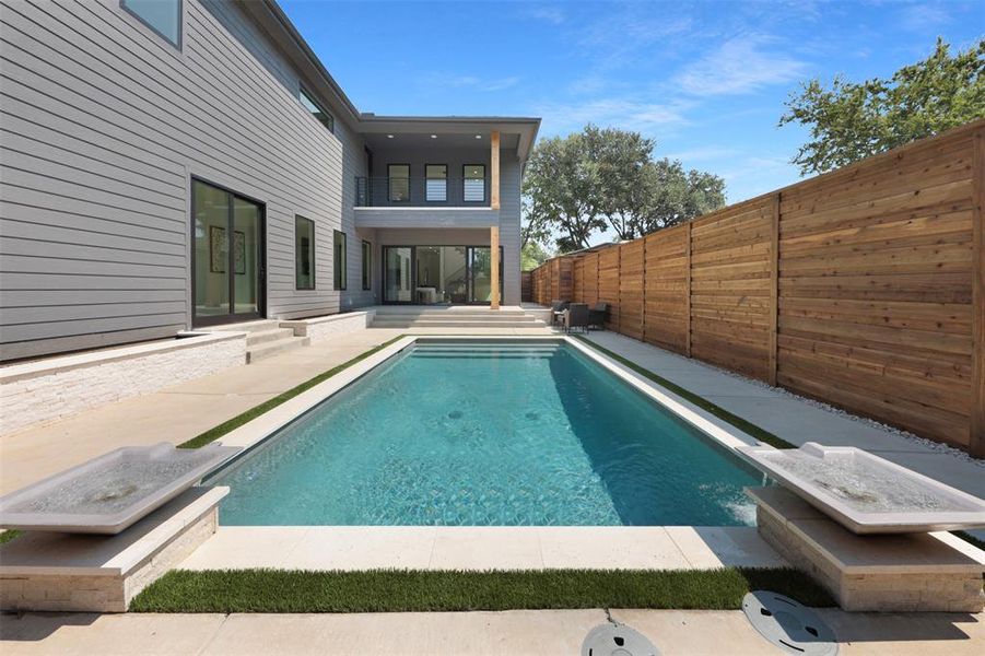 View of swimming pool with a patio, a fenced backyard, and a balcony