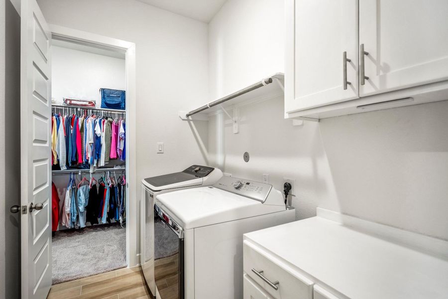 Walk through the laundry room and connect with 1 of 2 primary walk-in closets.