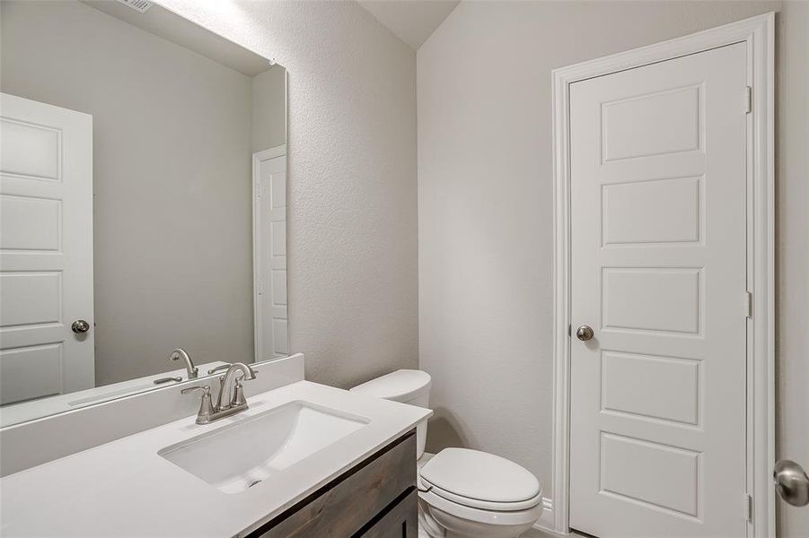 Bathroom with toilet and vanity Bathroom with toilet and vanity