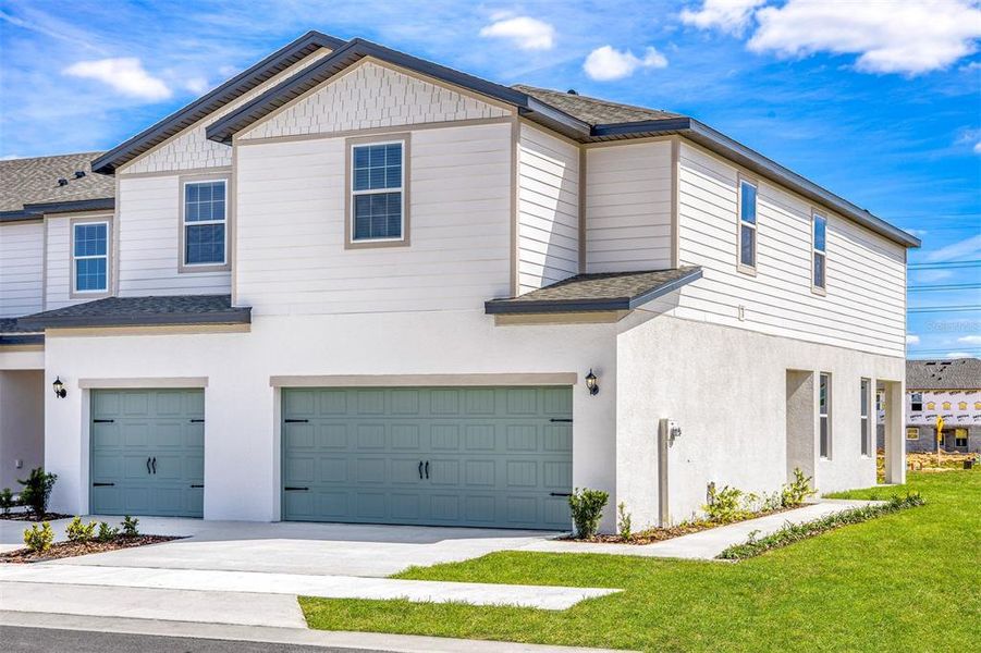 Front exterior of a new home in Sol Vista, Dundee, FL, highlighting curb appeal (Image 2). Front exterior of a new home in Sol Vista, Dundee, FL, highlighting curb appeal (Image 2).