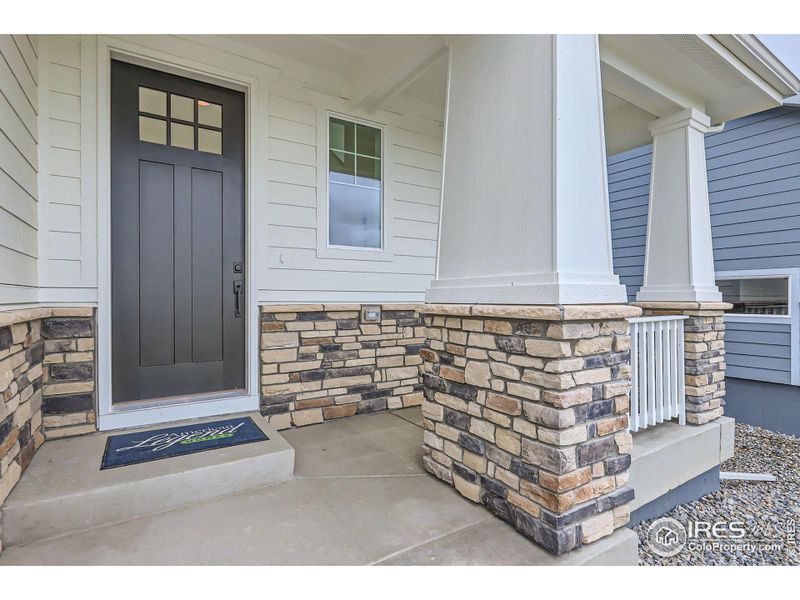 Front exterior of a new home in Barefoot Lakes, Longmont, CO, highlighting curb appeal (Image 17).