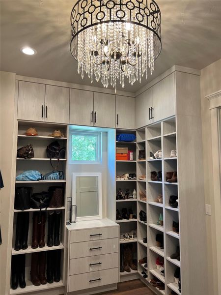 Primary Closet fit for a queen with shoe storage and beautiful chandelier Primary Closet fit for a queen with shoe storage and beautiful chandelier
