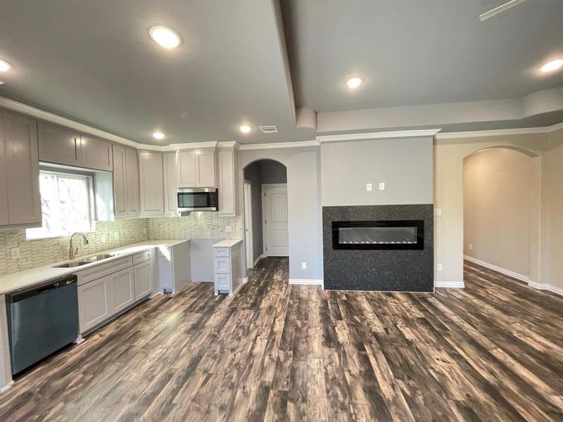 Kitchen with sink, gray cabinetry, stainless steel appliances, and dark hardwood / wood-style floors