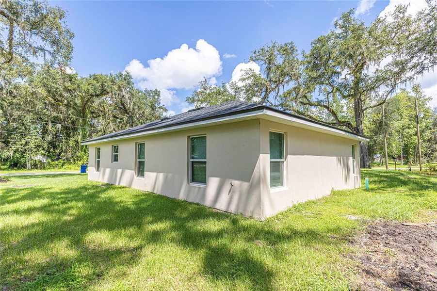 Front exterior of a new home in , Lake Panasoffkee, FL, highlighting curb appeal (Image 12).