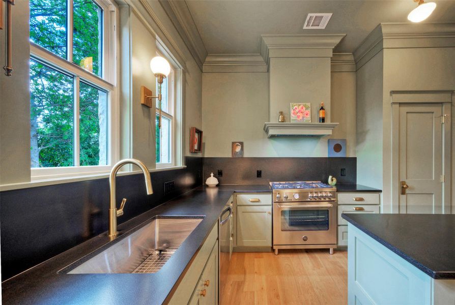 A refined kitchen showcases black granite countertops creating a modern culinary space.