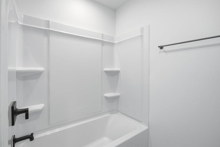 A bathroom with a bathtub and toilet.