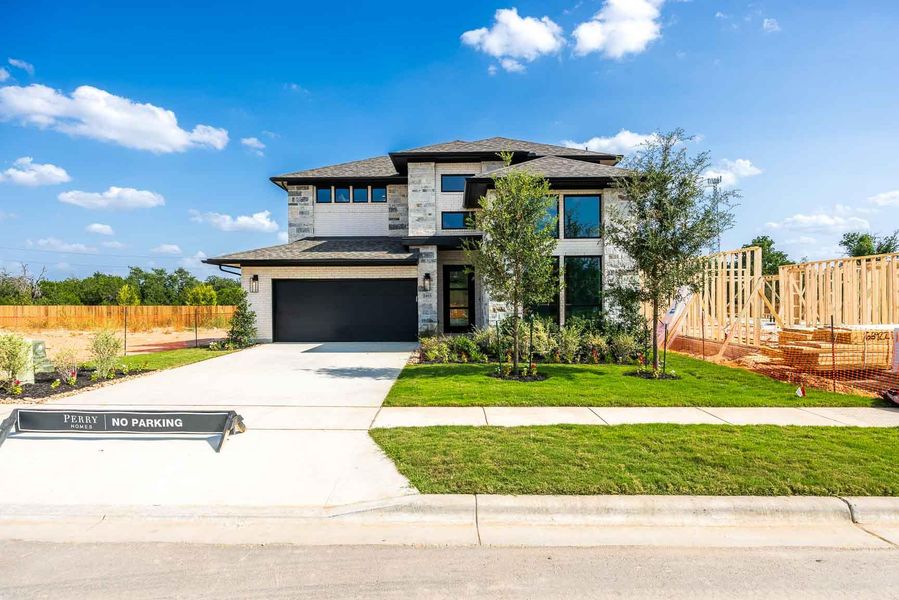 Front exterior of a new home in Parkside Peninsula, Georgetown, TX, highlighting curb appeal (Image 2).