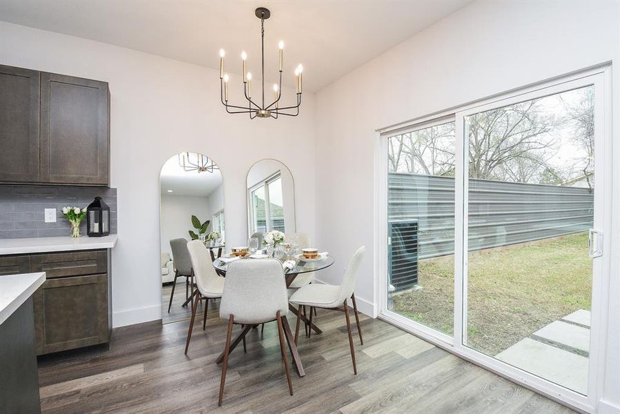 The minimal chandelier delivers quiet maximum beauty with arched mirrors adding dimension to this cozy space, overlooking patio and backyard.