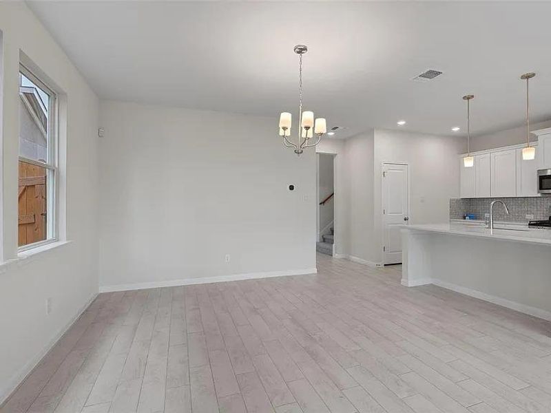 An open-concept living space integrates a well-appointed kitchen with an island, creating a fluid layout for daily living.