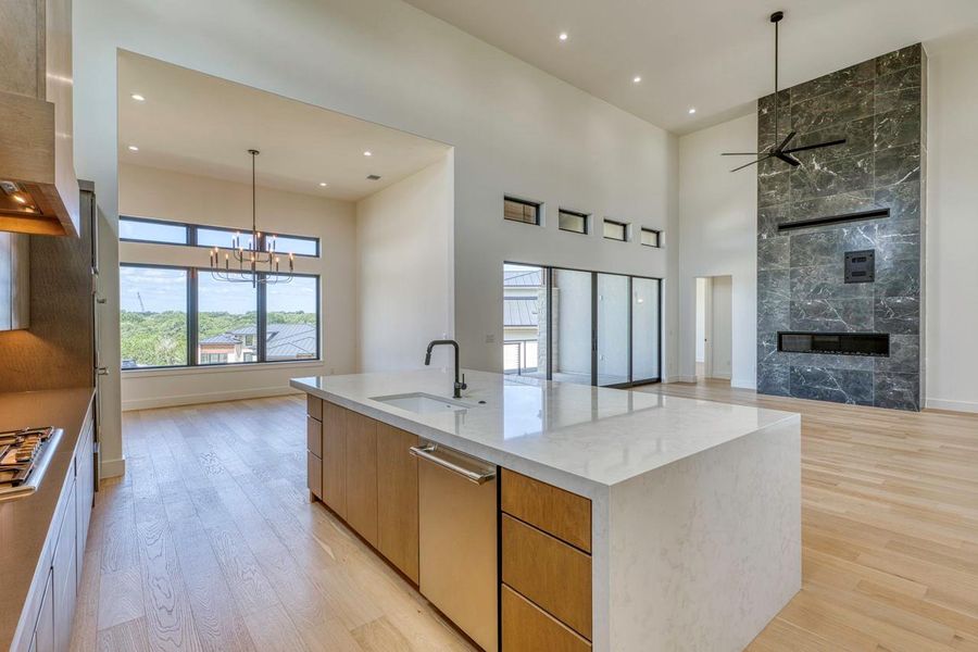 Hardwood floors and soaring ceilings create an open, airy ambience throughout the living space.
