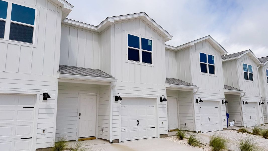 Front exterior of a new home in Salt Creek Townhomes at Mexico Beach, Mexico Beach, FL, highlighting curb appeal (Image 2). Front exterior of a new home in Salt Creek Townhomes at Mexico Beach, Mexico Beach, FL, highlighting curb appeal (Image 2).